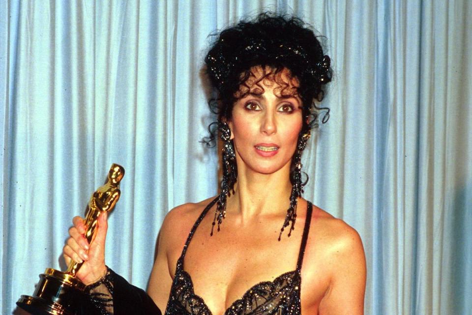 Cher collects her Oscar for ‘Moonstruck’ in 1988 (Eugene Adebari/Shutterstock)