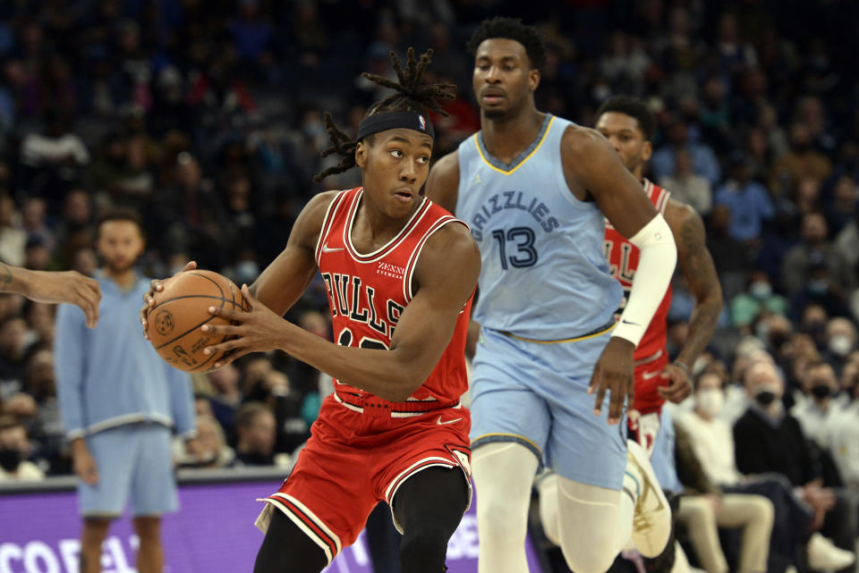 Chicago Bulls guard Ayo Dosunmu (12) handles the ball ahead of Memphis Grizzlies forward Jaren Jackson Jr. (13) in the second half of an NBA basketball game Monday, Jan. 17, 2022, in Memphis, Tenn. (AP Photo/Brandon Dill)