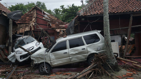 Damaged cars are seen among collapsed houses after a tsunami hit Banten, Indonesia, December 23, 2018 in this photo taken by Antara Foto. Antara Foto/Dian Triyuli Handoko/ via REUTERS