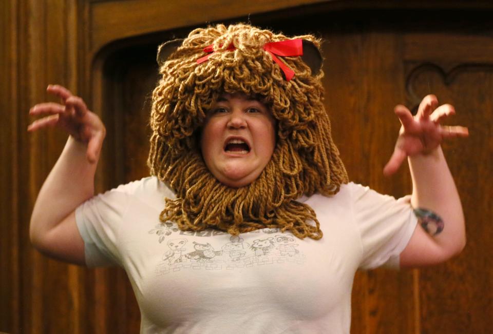 Hannah Storch plays it up as she tries on the Lion headpiece during a "The Wizard of Oz" rehearsal. Ohio Shakespeare Festival co-designer Marty LaConte created it from 30 skeins of yarn.