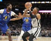 San Antonio Spurs guard Dejounte Murray, right, prepares to shoot as Denver Nuggets forward JaMychal Green, left, and guard P.J. Dozier defend during the first half of an NBA basketball game Friday, Oct. 22, 2021, in Denver. (AP Photo/David Zalubowski)