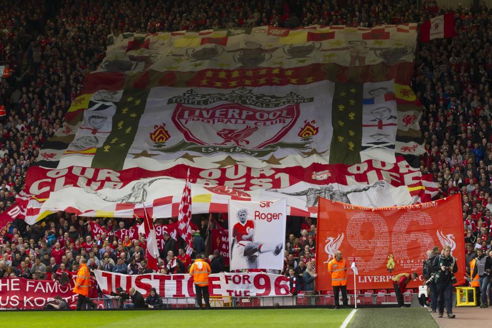 Before their English Premier League soccer match at Anfield Stadium against Manchester City Liverpool supporters hold banners prior to a minute's silence in tribute to the 96 supporters who lost their lives in the Hillsborough disaster of 25 years ago on 15 April 1989, Liverpool, England, Sunday April 13, 2014. (AP Photo/Jon Super)