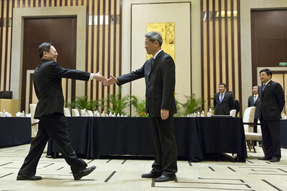 Wang Yu-chi, head of Taiwan's Mainland Affairs Council, left, shakes hands with Zhang Zhijun, director of China's Taiwan Affairs Office, right, before their meeting in Nanjing, in eastern China's Jiangsu Province, Tuesday, Feb. 11, 2014. Taiwan and China are holding their highest-level talks since splitting amid a civil war 65 years ago, hoping to further boost contacts and ease lingering tensions, even as political developments on the self-governing island swing away from Beijing's goal of eventual unification. (AP Photo/Alexander F. Yuan)