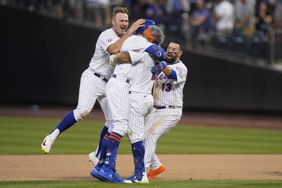 From left, New York Mets first baseman Pete Alonso, center fielder Brandon Nimmo, shortstop Francisco Lindor, and second baseman Luis Guillorme (13) celebrate after closing the tenth inning of a baseball game against the Miami Marlins, Saturday, July 9, 2022, in New York. (AP Photo/John Minchillo)