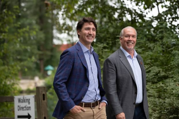 Prime Minister Justin Trudeau and Premier John Horgan arrive in Coquitlam, B.C. to announce a bilateral $10-a-day child care agreement on July 8, 2021.  (Darryl Dyck/The Canadian Press - image credit)