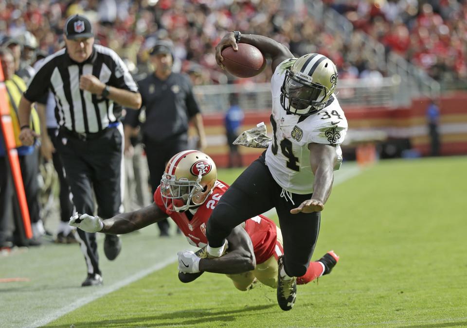 <p>New Orleans Saints running back Tim Hightower goes tumbling with ball while being stopped by San Francisco 49ers cornerback Tramaine Brock, left, during the first half of an NFL football game Sunday, Nov. 6, 2016, in Santa Clara, Calif. (AP Photo/Tony Avelar) </p>