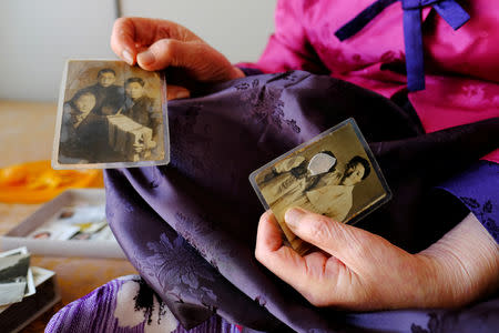 Lee Yong-soo, 90, one of less than 30 known surviving South Korean victims of JapanÕs wartime brothels, displays a photograph in Daegu, South Korea October 30, 2018, of her taken shortly after she returned to Korea in 1945 after being held at an airbase for kamikaze pilots in Taiwan. Picture taken October 30, 2018. REUTERS/Josh Smith