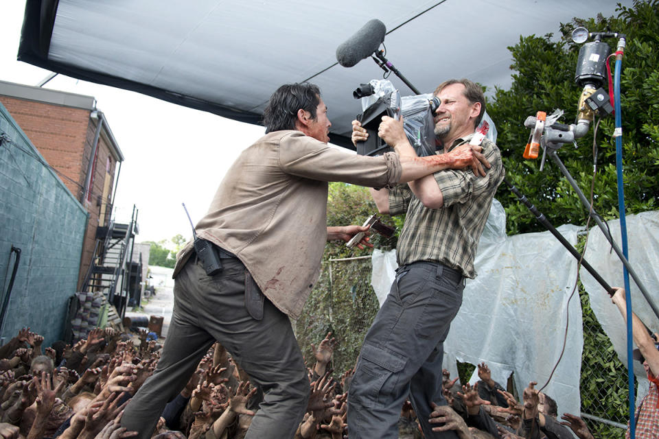 <p>Steven Yeun gets right up in the camera while filming the big Dumpster scene, i.e. the death he survived.<br><br>(Photo Credit: Gene Page/AMC) </p>
