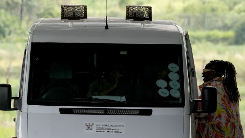 A prison official inspects a vehicle leaving the Correctional Services prison in Pretoria, South Africa, Friday, Jan. 5, 2024. South African athlete Oscar Pistorius has been released from prison on parole after serving nearly nine years in prison for killing his girlfriend and is now at home, South Africa’s Department of Corrections said Friday.