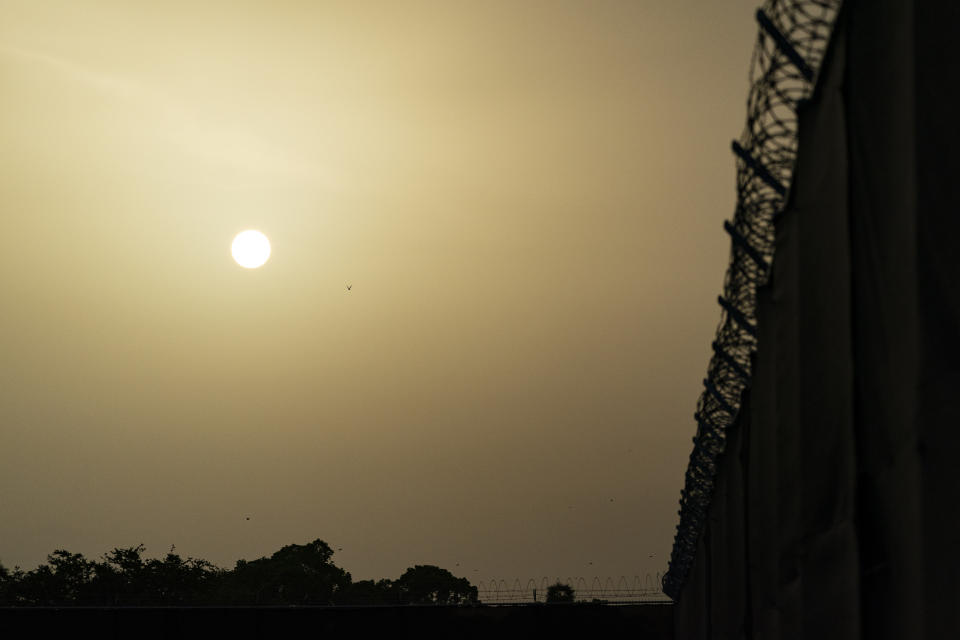 FILE - In this Aug. 29, 2021, file photo reviewed by U.S. military officials, the sun sets as seen from Camp Justice in Guantanamo Bay Naval Base, Cuba. Camp Justice is where the military commission proceedings are held for detainees charged with war crimes. The White House says it intends to shutter the prison on the U.S. base in Cuba, which opened in January 2002 and where most of the 39 men still held have never been charged with a crime. (AP Photo/Alex Brandon, File)