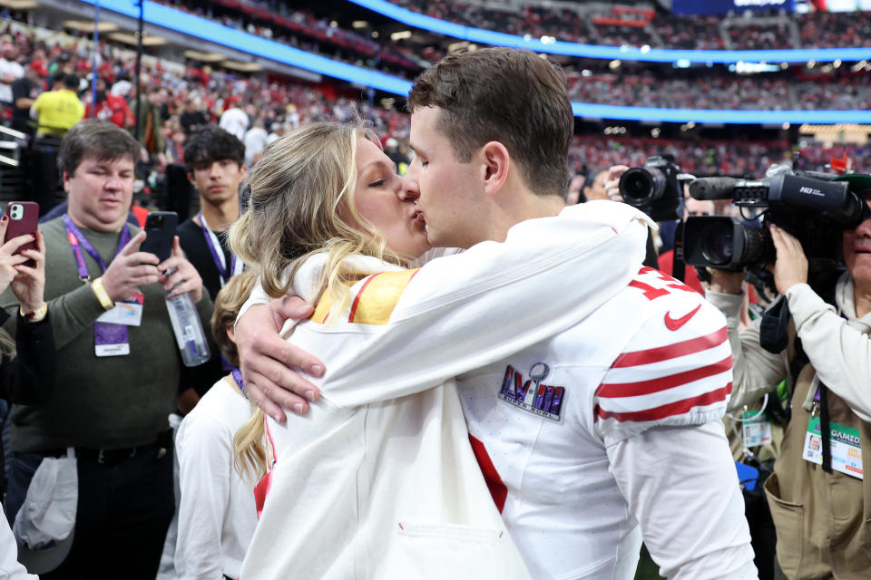 LAS VEGAS, NEVADA - FEBRUARY 11: Brock Purdy #13 of the San Francisco 49ers kisses fiancee Jenna Brandt before Super Bowl LVIII against the Kansas City Chiefs at Allegiant Stadium on February 11, 2024 in Las Vegas, Nevada. (Photo by Ezra Shaw/Getty Images)