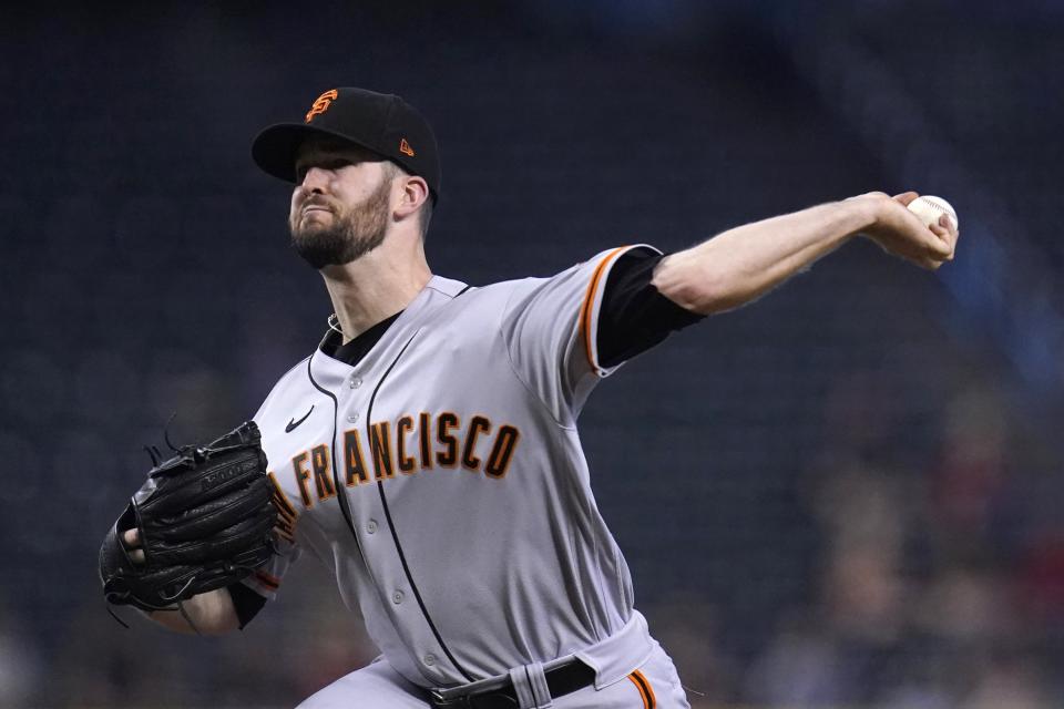 San Francisco Giants starting pitcher Alex Wood throws against the Arizona Diamondbacks during the first inning of a baseball game, Thursday, Aug. 5, 2021, in Phoenix. (AP Photo/Ross D. Franklin)