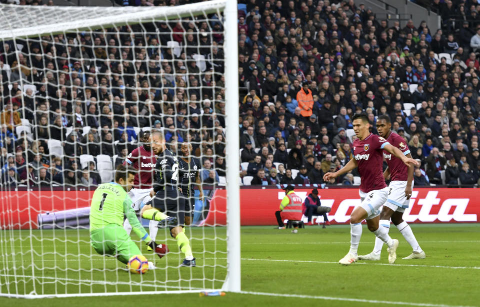 Manchester City's David Silva, third left, scores his side's first goal of the game during their English Premier League soccer match against West Ham United at The London Stadium, London, Saturday, Nov 24, 2018. (Dominic Lipinski/PA via AP)