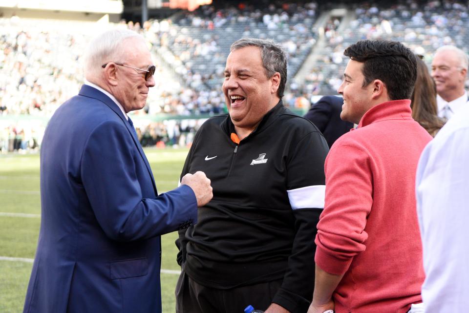 Dallas Cowboys owner Jerry Jones, former New Jersey Gov. Chris Christie and his son Andrew Christie talk on the field before a game in 2019.