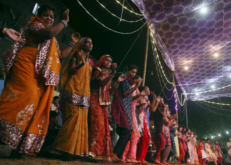 FILE - In this Thursday, Oct. 11, 2018 file photo, Hindus dance to celebrate the nine-day Navaratri festival in Karachi, Pakistan. It begins with what for many is considered the Hindu New Year and will culminate with the festival of Ramanavami. (AP Photo/Shakil Adil)