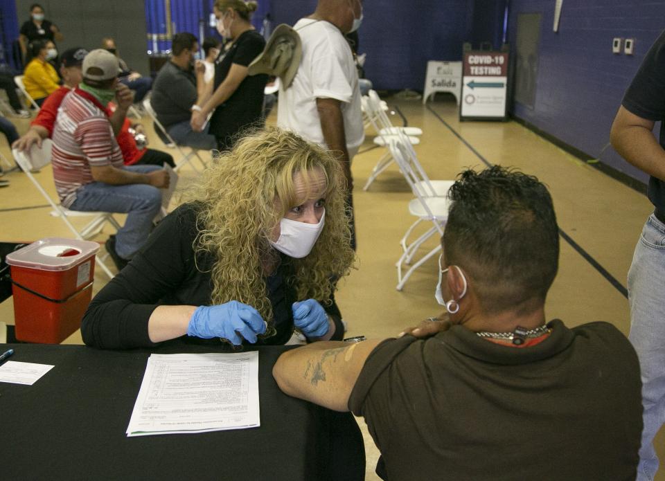 Arizona Department of Health Services Director Dr. Cara M. Christ talks to a person after giving them a COVID-19 vaccine at Grant Park Recreation Center in Phoenix.