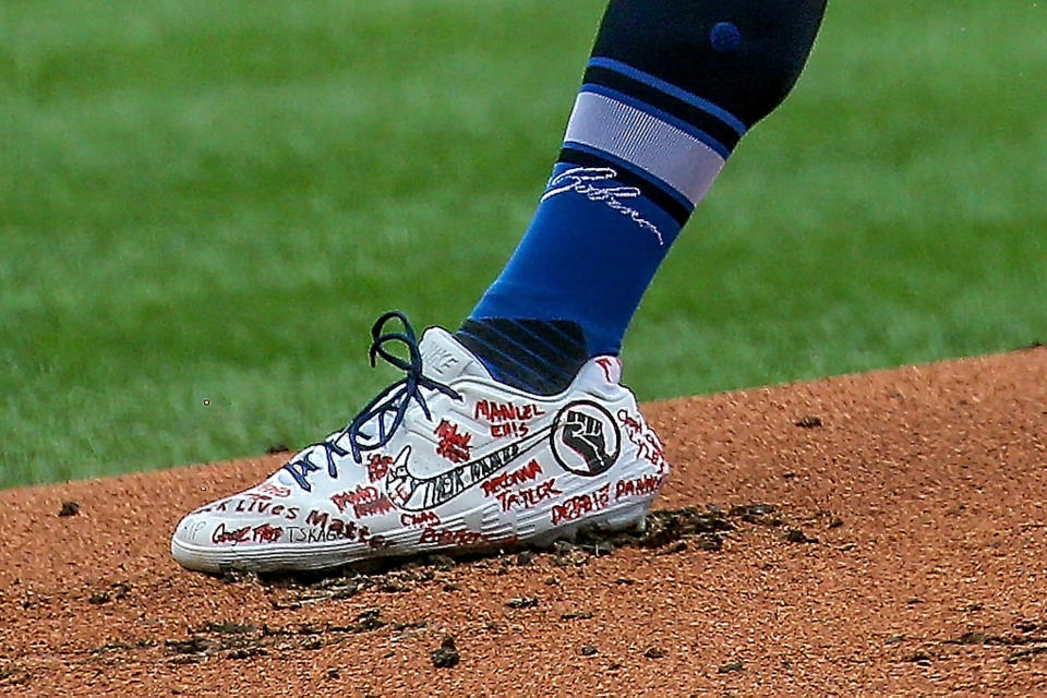 St. Louis Cardinals starting pitcher Jack Flaherty (22) wears cleats supporting the Black Lives Matter movement during the first inning of a baseball game against the Cleveland Indians, Saturday, Aug. 29, 2020, in St. Louis. (AP Photo/Scott Kane)