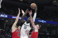 Memphis Grizzlies' Jaren Jackson Jr. (13) shoots as Chicago Bulls' Nikola Vucevic (9) and Alex Caruso defend during the first half of an NBA basketball game Tuesday, Feb. 7, 2023, in Memphis, Tenn. (AP Photo/Karen Pulfer Focht)