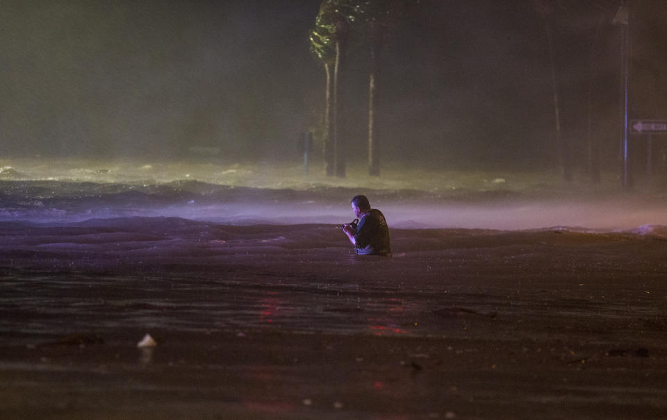 <p>Lanny Dean, from Tulsa, Oklahoma, takes video as he wades along a flooded Beach Boulevard next to Harrahs Casino as the eye of Hurricane Nate pushes ashore in Biloxi, Mississippi October 8, 2017. Hurricane Nate flooded the parking garage and first floors of Golden Nugget, Harrahs and other casinos as it made a second landfall on the Mississippi coast as a category 1 storm. (Photo: Mark Wallheiser/Getty Images) </p>