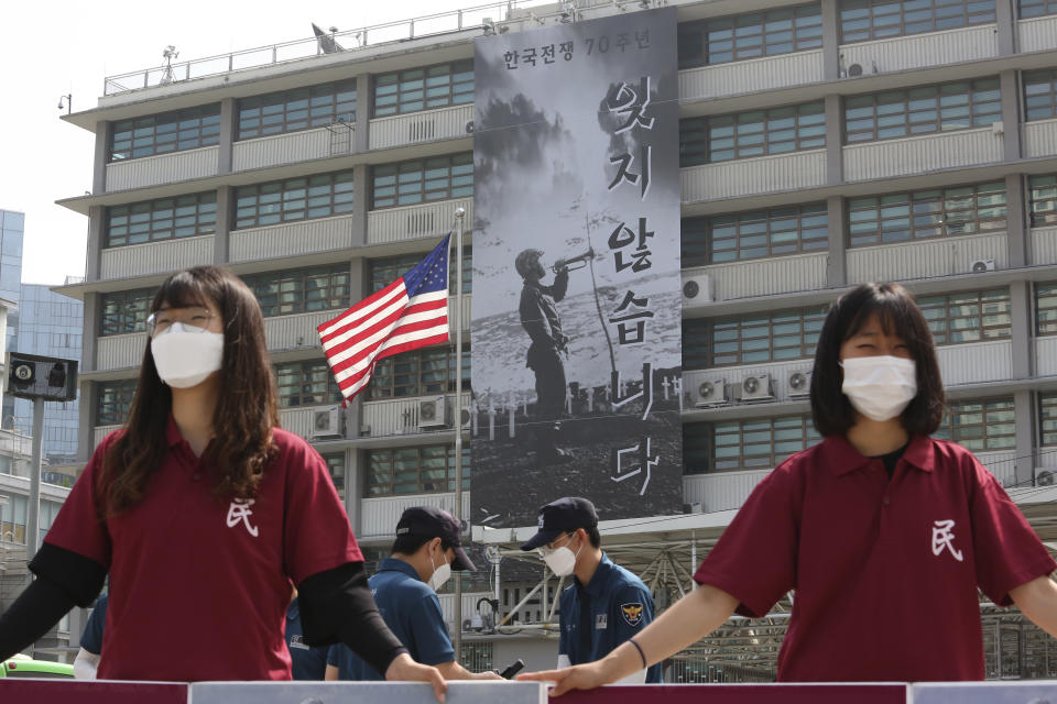 A banner to commemorate the 70th anniversary of the start of the 1950-53 Korean War is displayed after a "Black Lives Matter" banner was taken down, while protesters stage a rally demanding withdrawal of U.S. troops from Korea Peninsula, at the U.S. Embassy in Seoul, South Korea, Tuesday, June 16, 2020. The large Black Lives Matter banner has been removed from the U.S. Embassy building three days after it was raised there in solidarity with protesters back home. The sign reads "Don't forget it." (AP Photo/Ahn Young-joon)