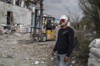 An injured man looks on following a Russian bombing of a factory in Kramatorsk, in eastern Ukraine, on Tuesday, April 19, 2022. Russian forces attacked along a broad front in eastern Ukraine on Tuesday as part of a full-scale ground offensive to take control of the country's eastern industrial heartland in what Ukrainian officials called a "new phase of the war." (AP Photo/Petros Giannakouris)