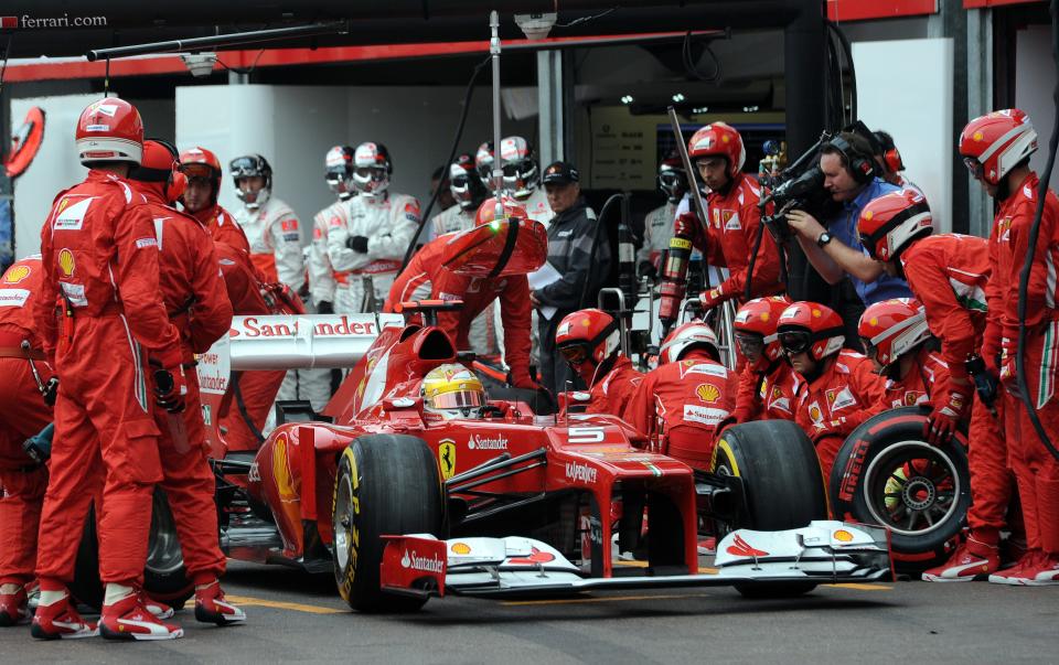 Mechanics work on the car ofFerrari's Spanish driver Fernando Alonso in the pits at the Circuit de Monaco on May 27, 2012 in Monte Carlo during the Monaco Formula One Grand Prix. AFP PHOTO / DIMITAR DILKOFFDIMITAR DILKOFF/AFP/GettyImages