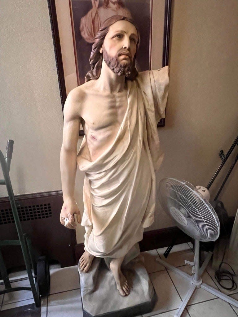Before its restoration, the Christ statue "looked like he fell down the steps and broke his arm," said Rev. Peter Palmisano of Our Lady of Mount Virgin Church in Garfield. Art restorer Rafael Sebasco reattached the limb with cement and repainted it.