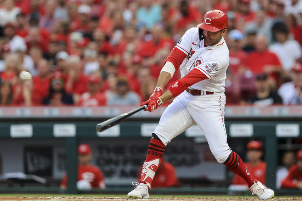 Cincinnati Reds' Joey Votto hits an RBI-single during the third inning of a baseball game against the Atlanta Braves in Cincinnati, Thursday, June 24, 2021. (AP Photo/Aaron Doster)