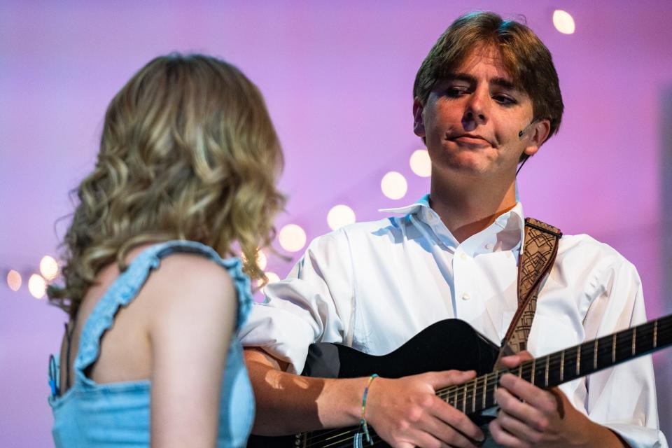 Gabe Stadtmueller, as Harry Bright, holds a guitar during a dress rehearsal for an upcoming PSD performance of 'Mamma Mia!' at Fossil Ridge High School on Tuesday in Fort Collins.