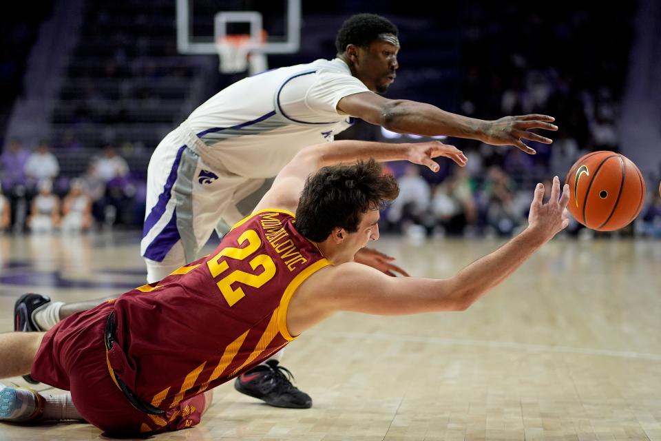 Iowa State forward Milan Momcilovic (22) and Kansas State guard Cam Carter chase a loose ball on Saturday. Momcilovic, a freshman, was held scoreless for the first time in his career in the 65-58 loss.