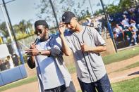 Diddy mans the mic on Saturday during a baseball game with son Quincy Brown at a private school in Los Angeles. 