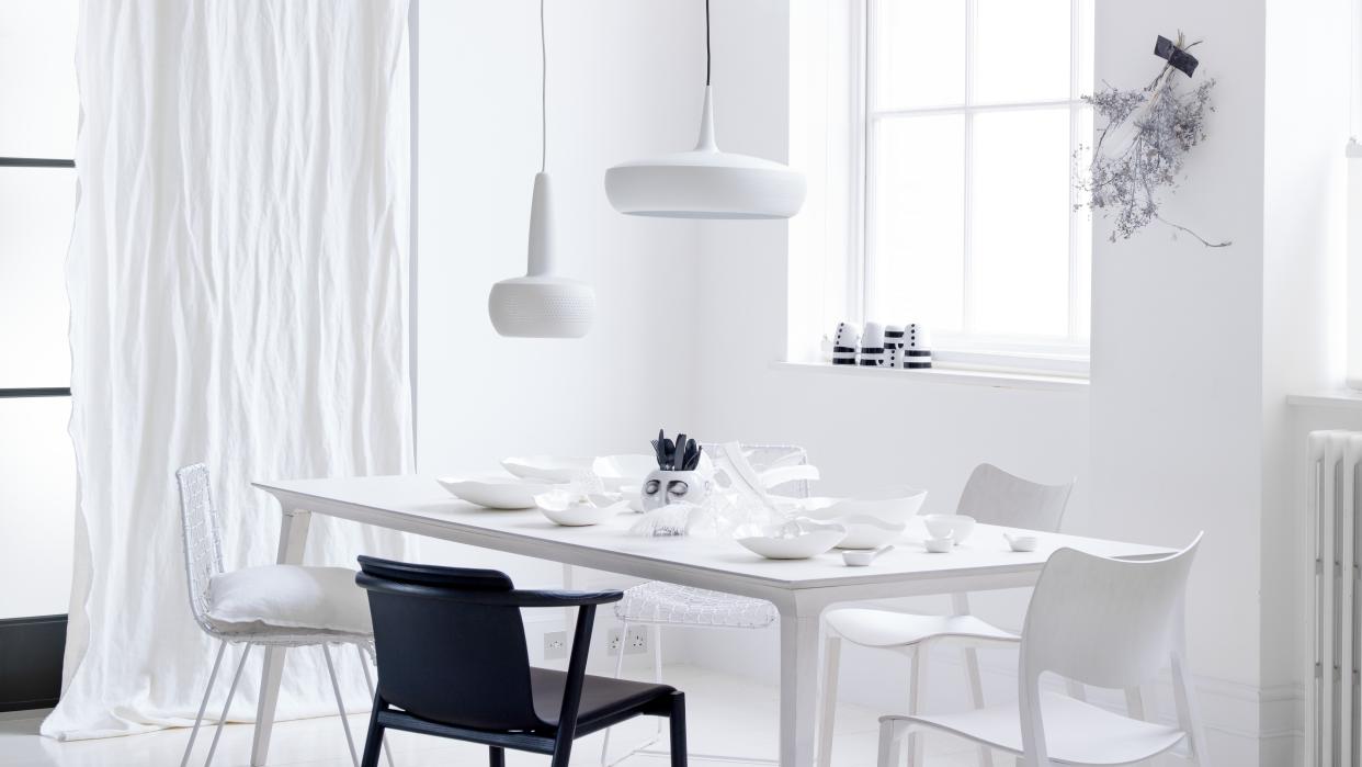  A crisp white room with one black chair. 