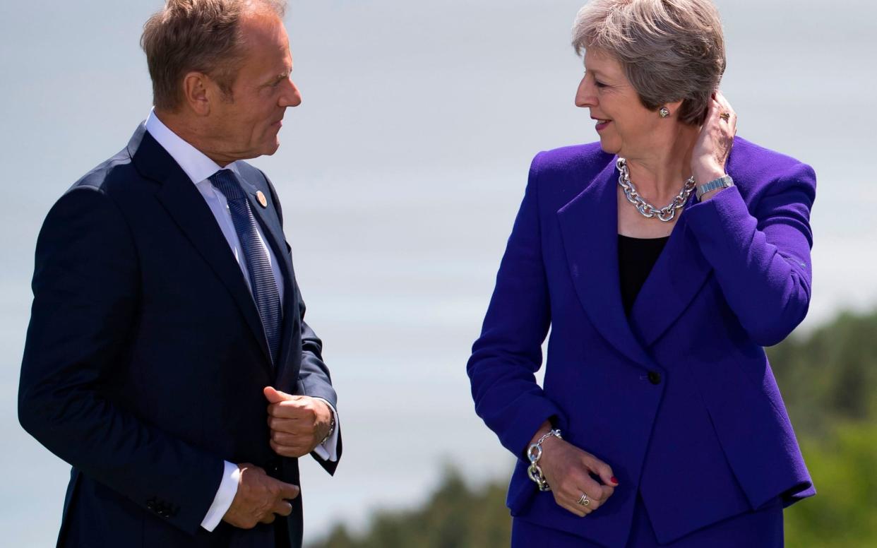  Prime Minister Theresa May and European Council President Donald Tusk attend the family photo at the G7 Summit in La Malbaie, Canada,  - AFP