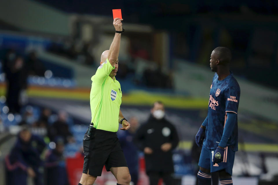 Nicolas Pepe (right) is shown a red card by referee Anthony Taylor during Arsenal's Premier League with Leeds United