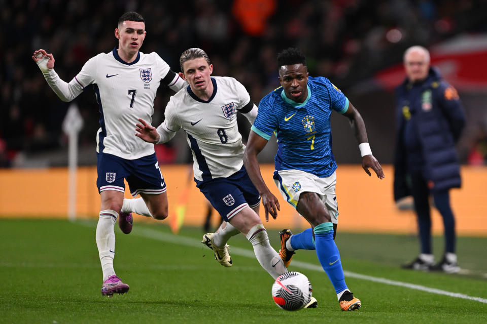 LONDON, ENGLAND - MARCH 23: Vinicius Junior of Brazil gets away from Phil Foden and Conor Gallagher of England during the international friendly match between England and Brazil at Wembley Stadium on March 23, 2024 in London, England. (Photo by Mike Hewitt/Getty Images)