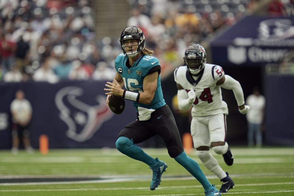 Jacksonville Jaguars quarterback Trevor Lawrence (16) scrambles out of the pocket against the Houston Texans on Sunday, Sept. 12, 2021, in Houston.