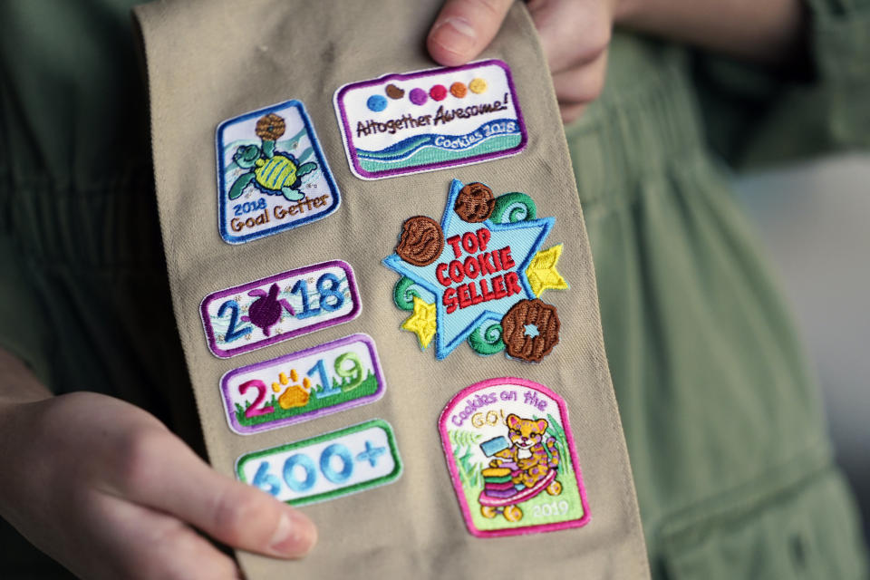 Olivia Chaffin, 14, displays merit badges Nov. 1, 2020, that she has been awarded for selling Girl Scout Cookies in Jonesborough, Tenn. She was a top cookie seller in her troop when she first heard rainforests were being destroyed to produce palm oil. (AP Photo/Mark Humphrey)