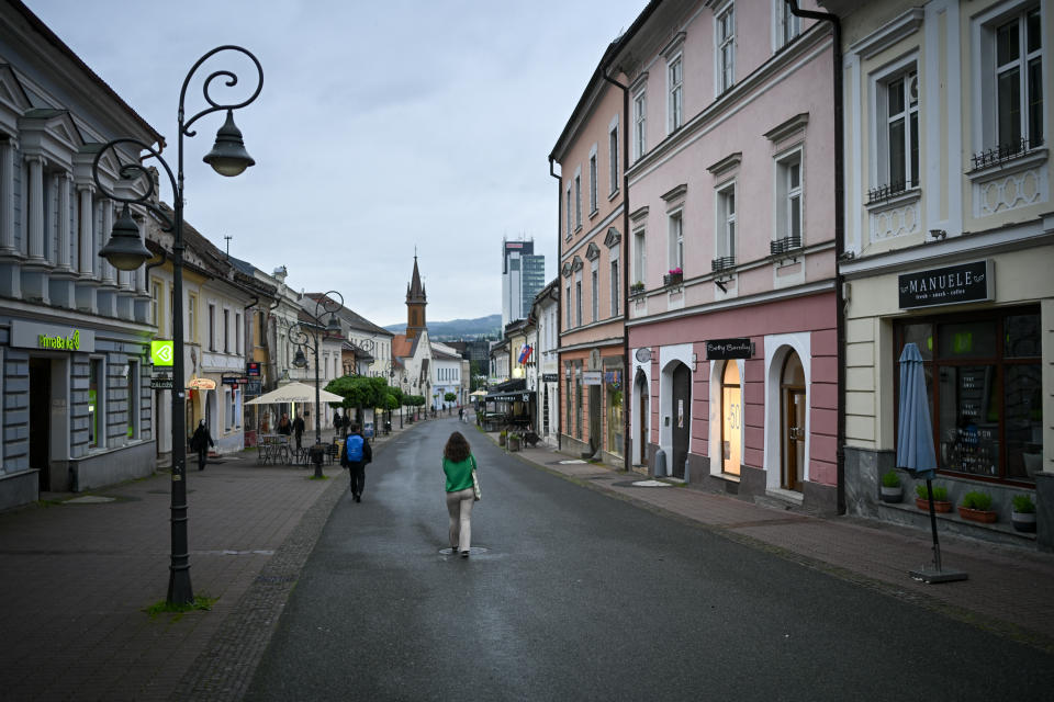People walk in Banska Bystrica, central Slovakia, Friday, May 17, 2024. When a gunman shot Slovak Prime Minister Robert Fico this week, shock rippled across the Central European country — even though the pro-Russia leader himself warned that the country was so divided that an assassination attempt was possible. (AP Photo/Denes Erdos)