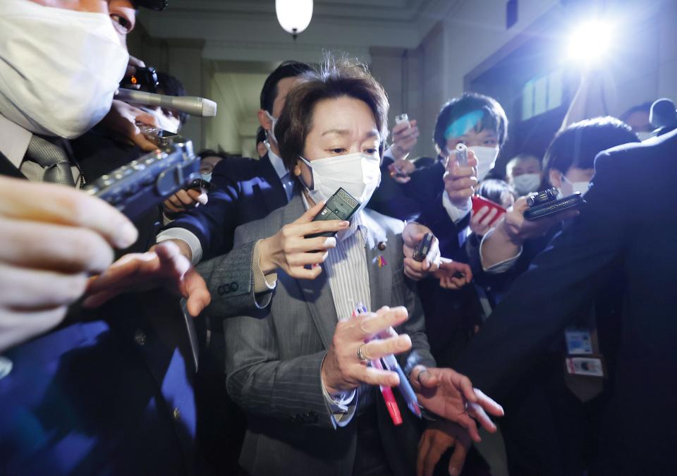 Japan's Olympics Minister Seiko Hashimoto, center, is surrounded by reporters at the Lower House in Tokyo, Wednesday, Feb. 17, 2021. Japan's Kyodo news agency, citing a source “familiar with the matter,” said a selection committee will ask Hashimoto to become the new president of the Tokyo Olympic organizing committee. Hashimoto, who could be named this week, would replace Yoshiro Mori who was forced to resign last week after he made demeaning comments about women — basically saying they talk too much.(Meika Fujio/Kyodo News via AP)