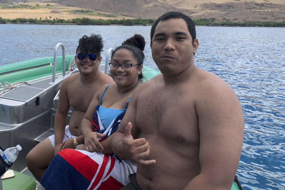 Po’omaika’i Estores-Losano, right, spending time with family off the coast of Maui on July 30, 2019. He remains missing nearly two weeks after the Aug. 8, 2023, fire in Lahaina, Hawaii The number of people still missing has dwindled after more families have found once-missing loved ones. But the number of missing remains substantial. (Photo courtesy of Leona Castillo.)