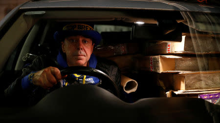 Anti-Brexit protester Steve Bray poses for a photograph as he sits in his car after a day of demonstrating outside the Houses of Parliament in London, Britain, December 10, 2018. REUTERS/Toby Melville