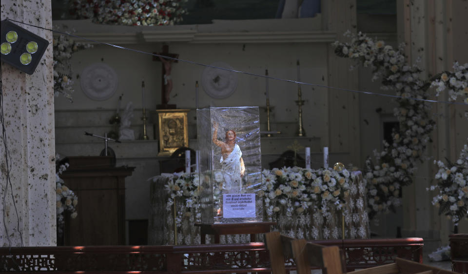 In this Thursday, April 25, 2019 photo, a statue of Jesus Christ stands on the altar of St. Sebastian's Church in Negombo, north of Colombo, Sri Lanka. Nearly a week later, the smell of death is everywhere, though the bodies are long gone. Yet somehow, there’s a beauty to St. Sebastian’s, a neighborhood church in a Catholic enclave north of Sri Lanka’s capital, where a man calmly walked in during Easter services with a heavy backpack and blew himself up. There is beauty in the little statues that refused to fall over, and despite the swarms of police and soldiers who seem to be everywhere now in the streets of the seaside town of Negombo. (AP Photo/Manish Swarup)