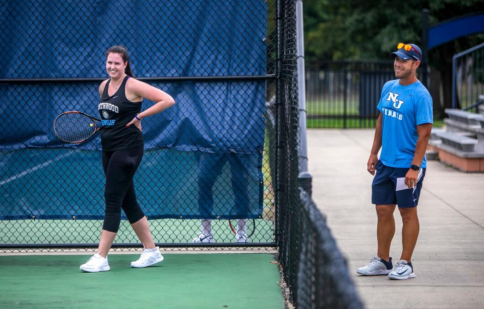 Iryna Trystan, 21, a Ukraine student from Northwood University, shares a smile with her tennis coach Mike Rose during the first official practice of the season at the Gerstacker Tennis Center in Midland on Thursday, Aug. 25, 2022. 