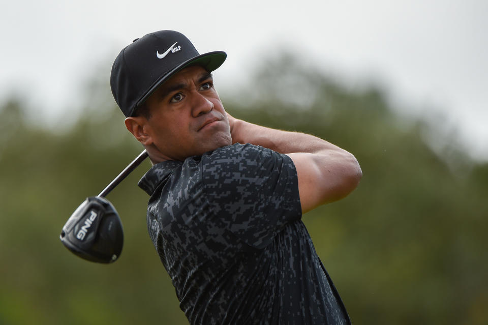 Tony Finau watches his tee shot during a golf tournament.