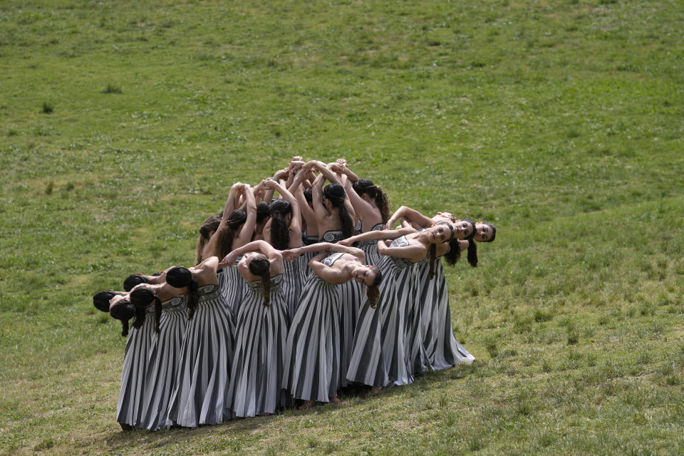 Performers take part in the official ceremony of the flame lighting for the Paris Olympics, at the Ancient Olympia site, Greece, Tuesday, April 16, 2024. The flame will be carried through Greece for 11 days before being handed over to Paris organizers on April 26. (AP Photo/Thanassis Stavrakis)