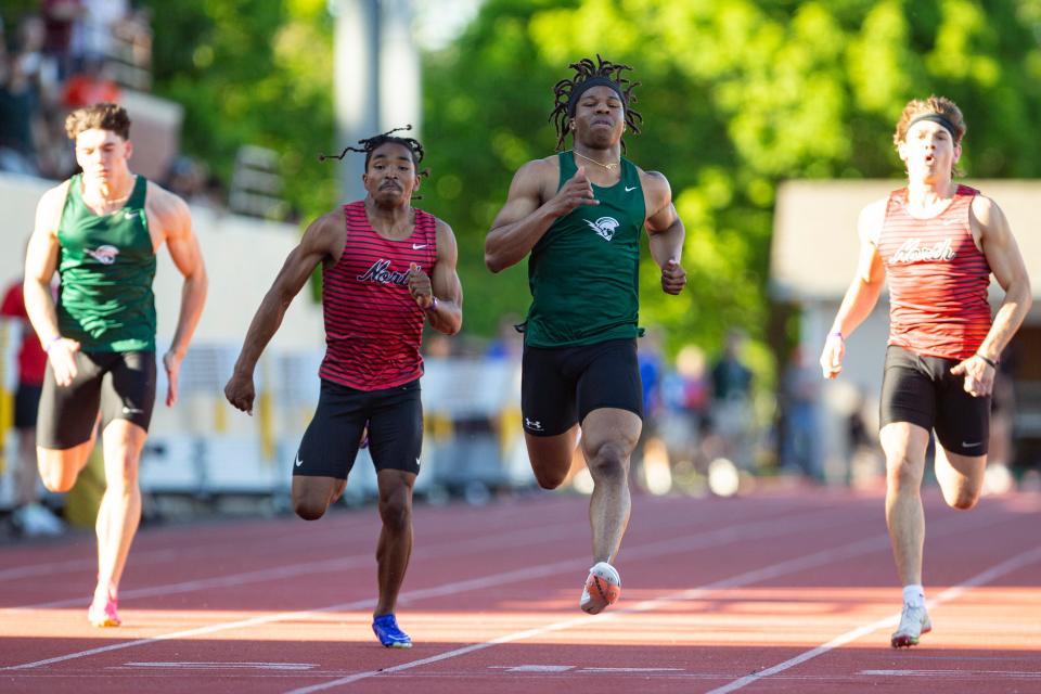 West Salem's Mihaly Akpamgbo, center right, wins the 100 meters during the CVC Track and Field District Championships at McCulloch Stadium on Friday, May 10, 2024, in Salem.