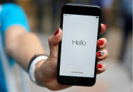 Ayano Tominaga poses with her Apple's new iPhone 7 after purchasing it at the Apple Store at Tokyo's Omotesando shopping district, Japan, September 16, 2016. REUTERS/Issei Kato TPX IMAGES OF THE DAY