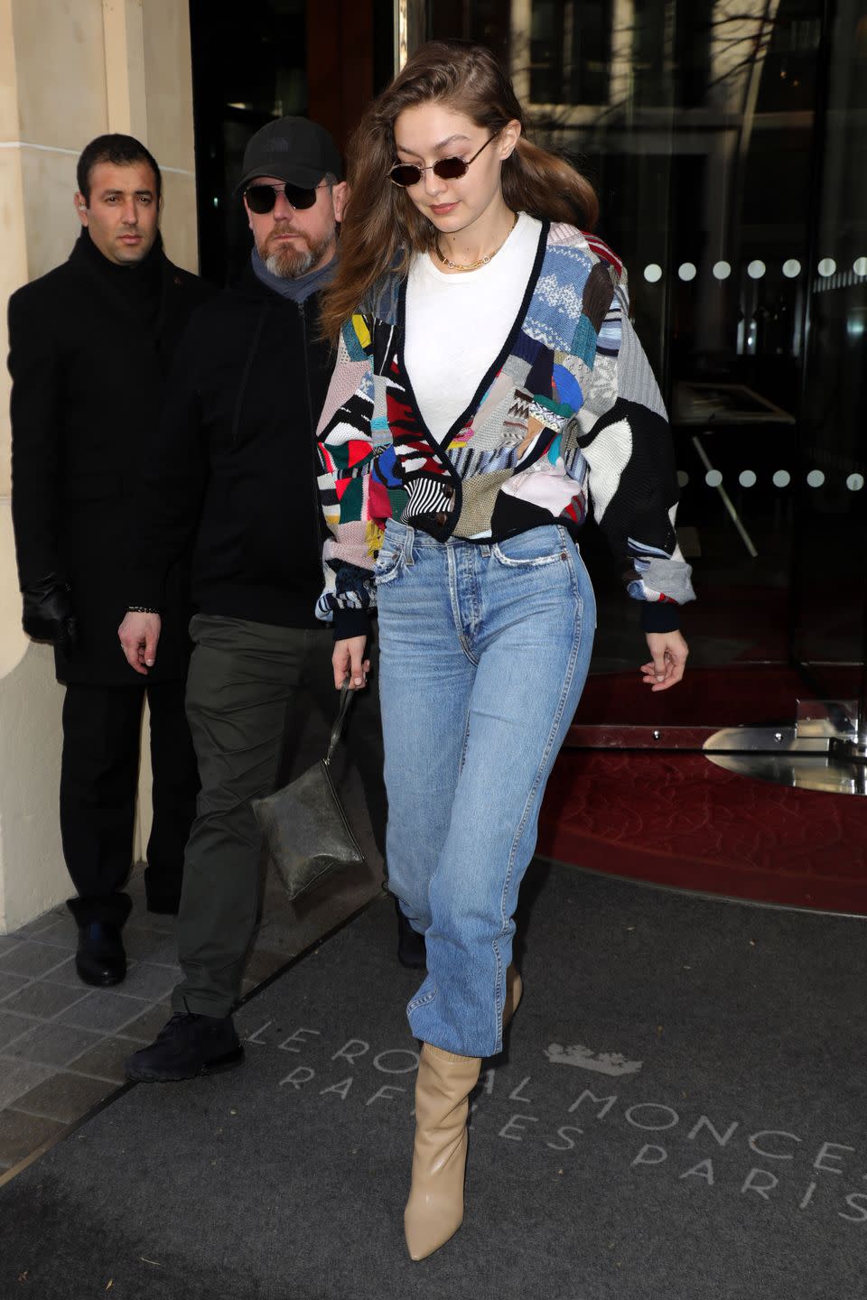 <p>Gigi's out here lookin' like she raided a vintage shop and I 100% approve this message. She leveled-up a grandpa sweater with a crisp white tee, mom jeans, and teeny shades. </p>