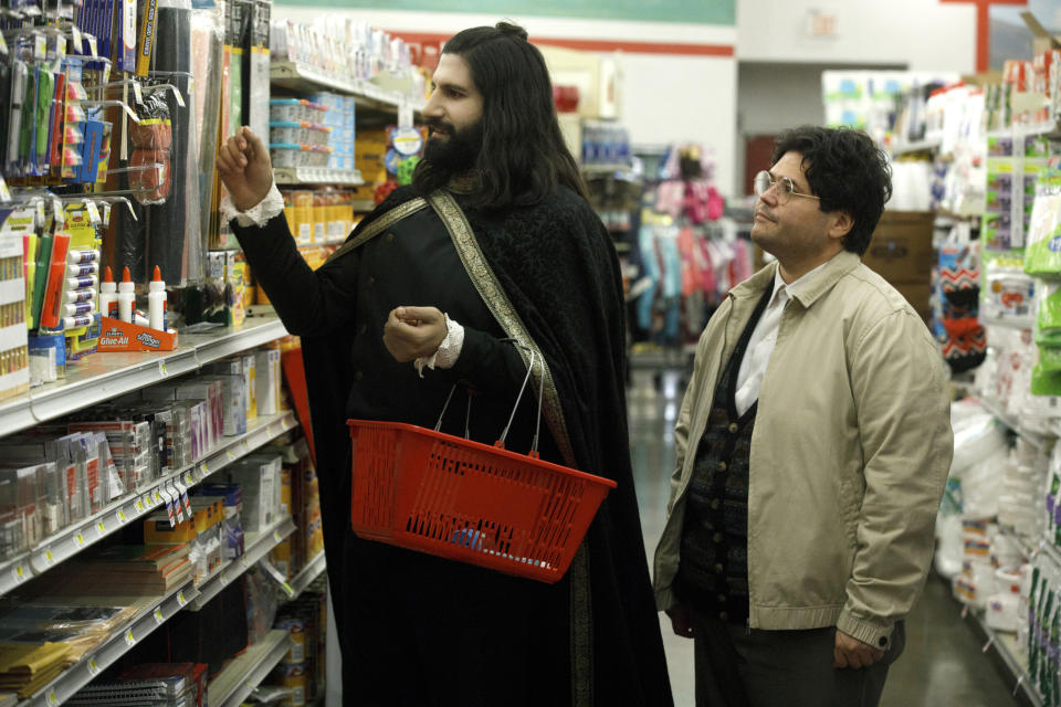 This image released by FX shows Kayvan Novak and Harvey Guillen, right, in a scene from "What We Do In the Shadows." The series premiering Wednesday is based on the 2014 cult-hit movie from New Zealand. (John P Johnson/FX via AP)