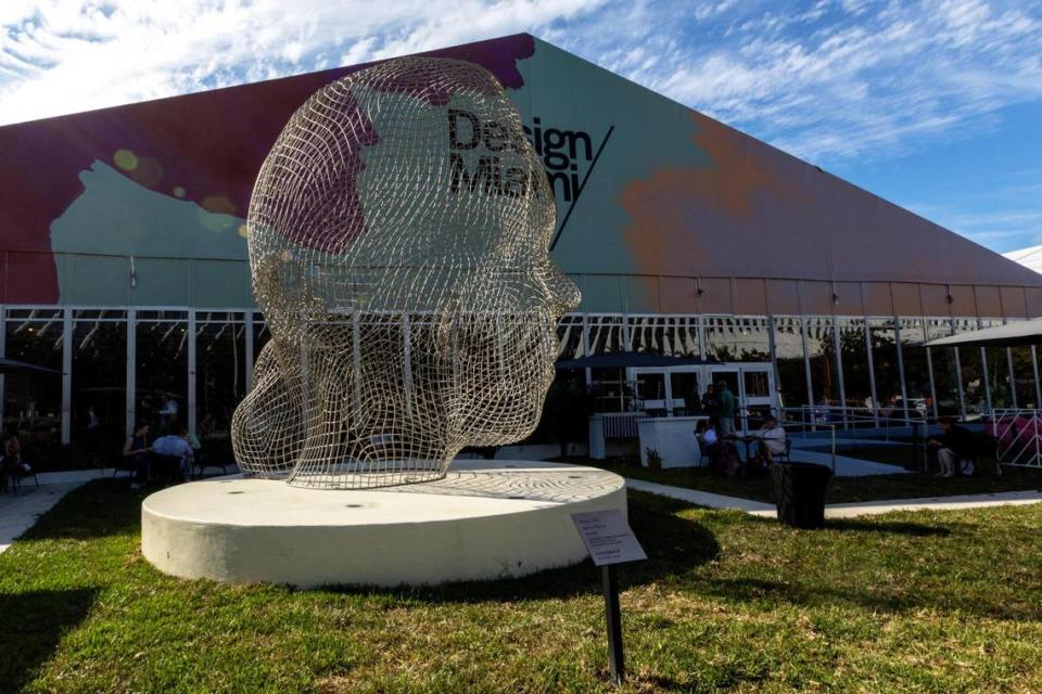 An exterior view of the Design Miami tent for Art Basel in Miami Beach, Florida, on Tuesday, December 5, 2023. The artwork displayed on the lawn is titled Minna, 2022 by Jaume Plensa.